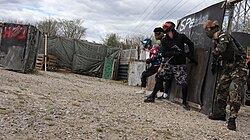Speedsoft players moving through an outdoor field with obstacles