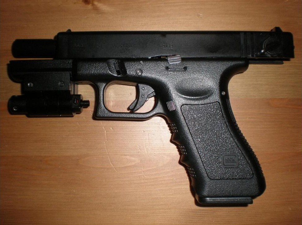 Airsoft GBB pistol replica with slide racked back showing the blowback action